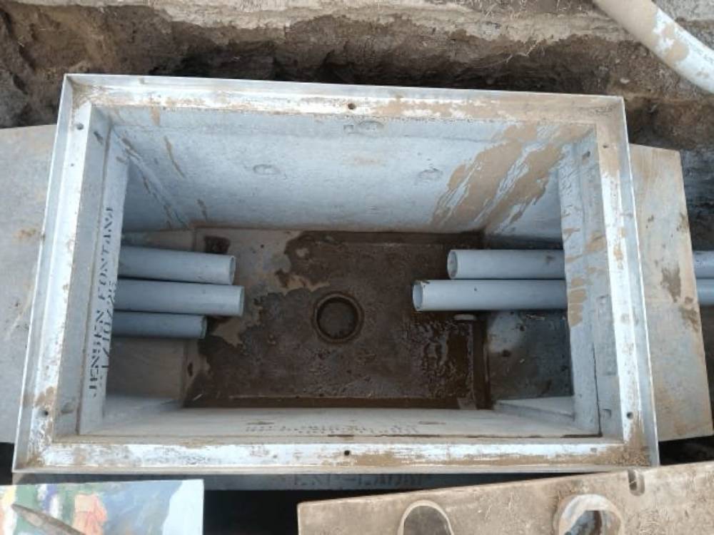 Precast concrete catch basin with PVC inlets, stamped Jensen Precast
